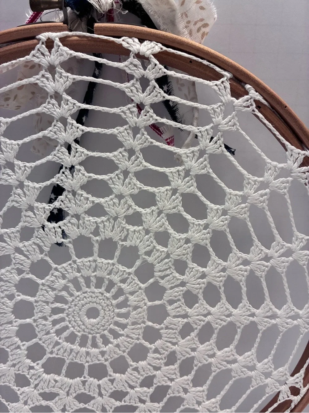 Handmade 10” crochet doily stretched inside a wooden embroidery hoop